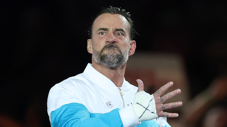 CM Punk holding his hand out