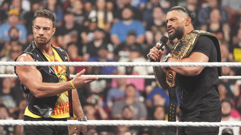 Roman Reigns and LA Knight standing in a WWE ring