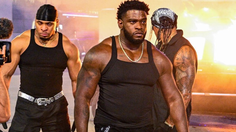 Royce Keys, Bronco Nima, and Lucien Price stand in front of a burning car they set on fire during a segment with The Bloodline on the September 7, 2026 edition of 