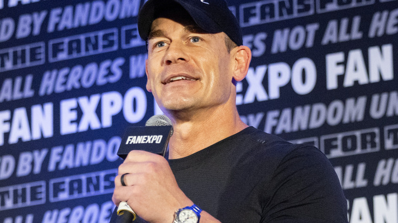 John Cena is holding a microphone