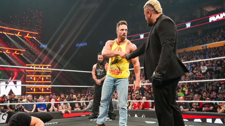 LA Knight and Solo Sikoa shake hands over a downed Roman Reigns in the ring, with Jacob Fatu looking on from the corner, during the August 17, 2026 edition of 