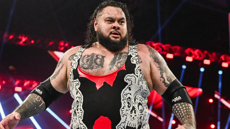 Bronson Reed is wearing a white and black wrestling singlet