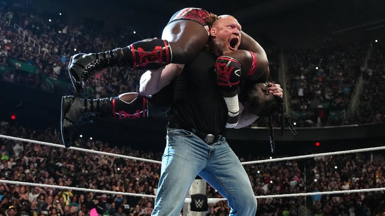Brock Lesnar with Oba Femi on his shoulders on WWE Raw