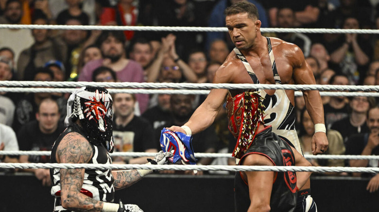 Chad Gable handing a lucha mask to Penta on 