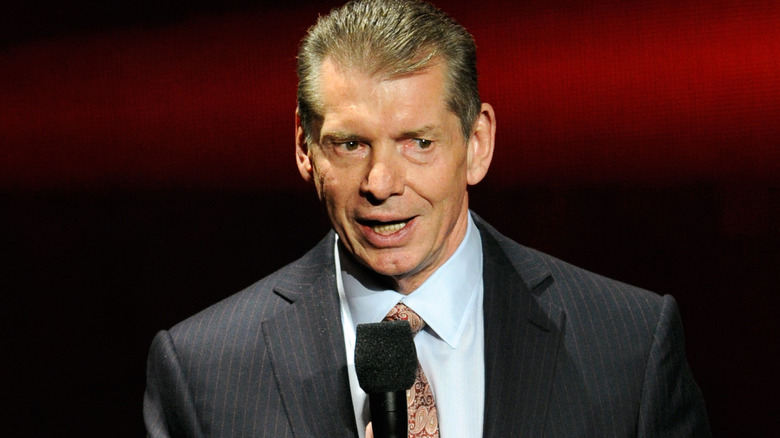 Vince McMahon holding a microphone
