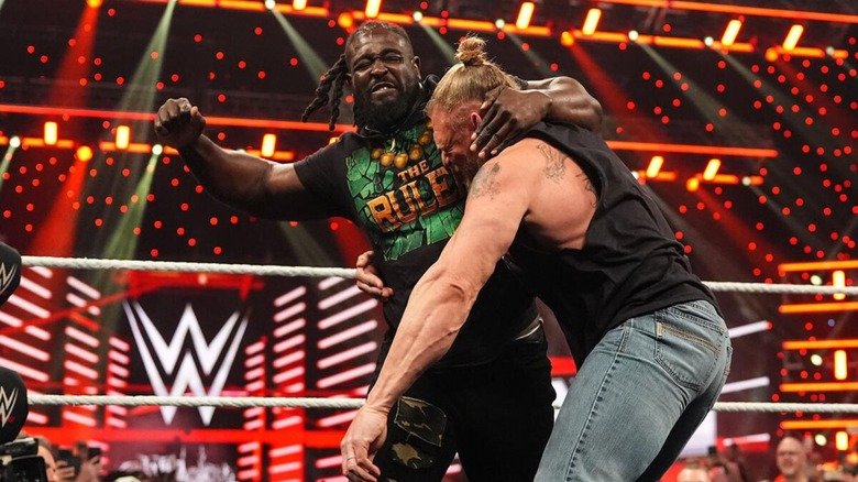 Oba Femi beats down on Brock Lesnar in the ring during their contract signing segment on 