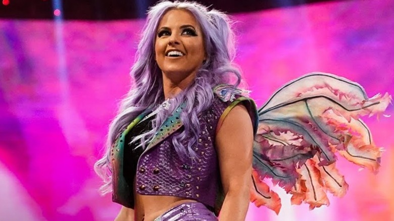 Candice LeRae smiling while wearing wings