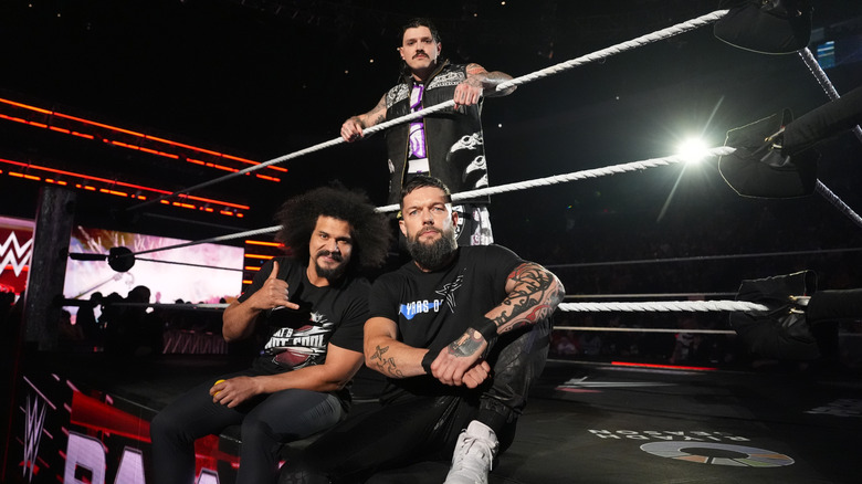 Carlito with the Judgment Day's Dominik Mysterio and Finn Balor