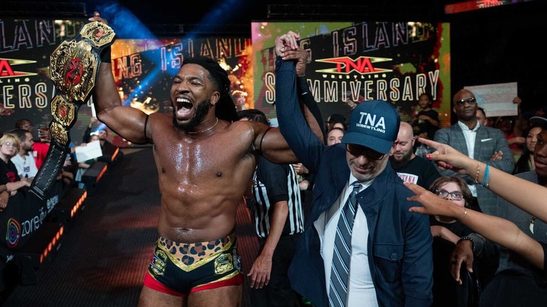 Trick Williams has his hand raised by TNA President Carlos Silva