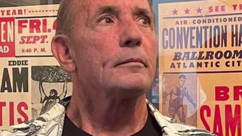 Former ROH owner Cary Silkin poses in front of classic wrestling posters