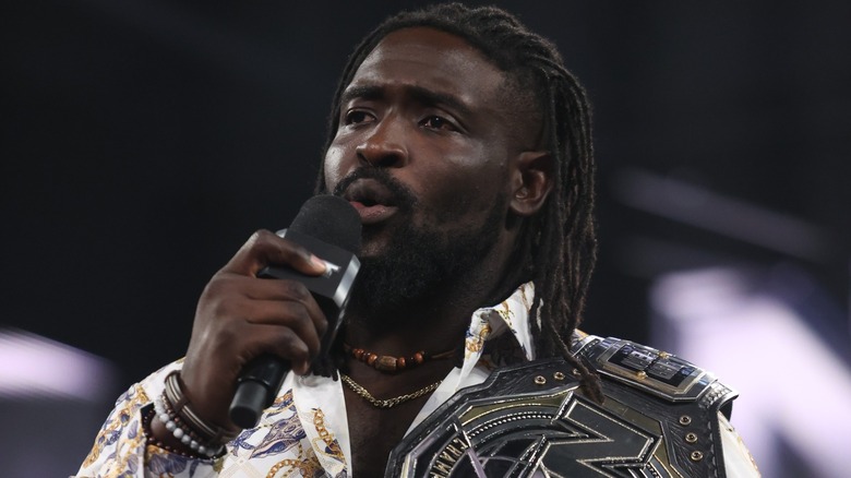 Oba Femi holding a microphone