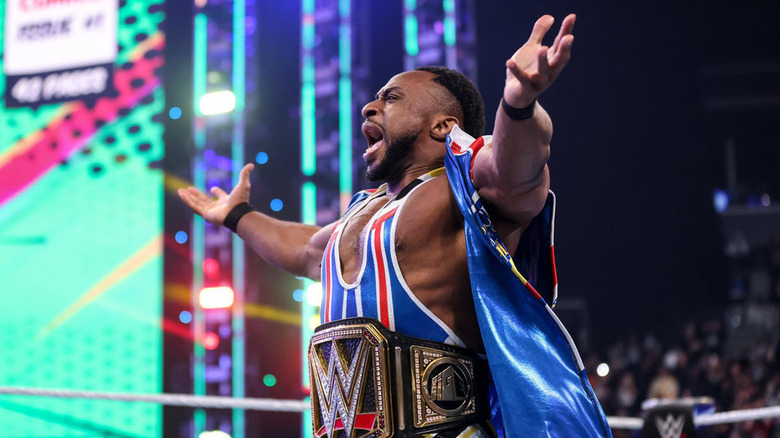 Big E standing in WWE ring with arms outstretched