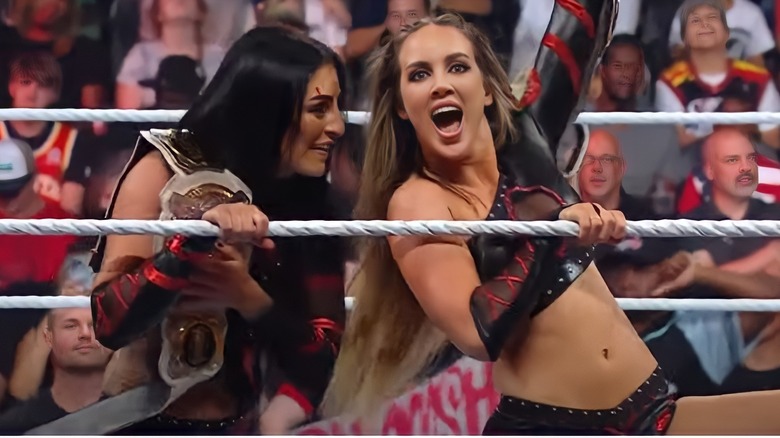 sonya deville emotional with tag team championship belt alongside excited chelsea green in ring