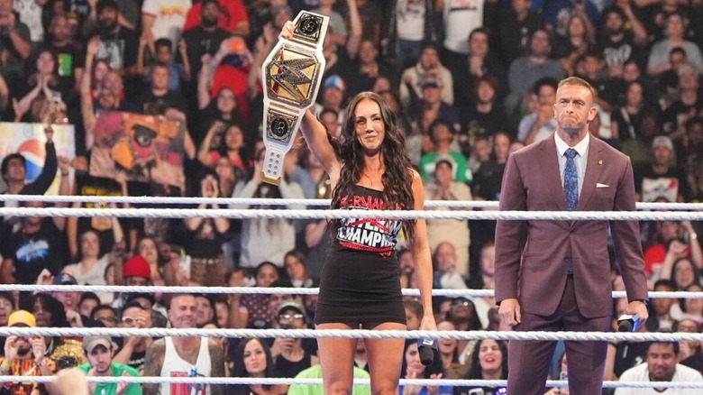 Chelsea Green raises the interim WWE Women's Championship in the ring as 