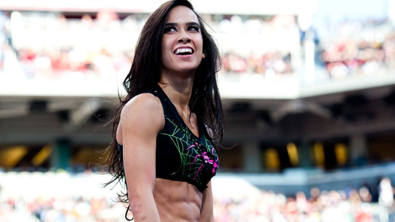 AJ Lee looks to the fans from the ring during a match on WWE programming.