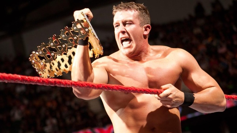 Ted DiBiase Jr. looks at the Million Dollar Championship in the ring after a victory in WWE.