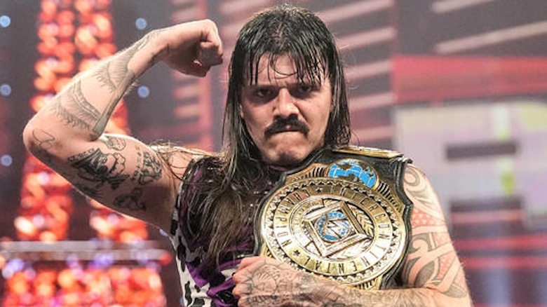 Dominik Mysterio flexes as WWE Intercontinental Champion