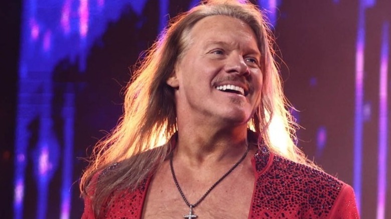 Chris Jericho smiles on before heading towards the ring