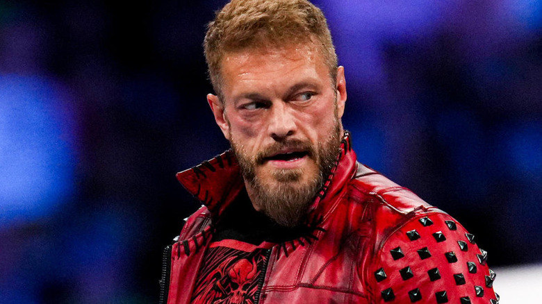 Edge wearing red leather jacket