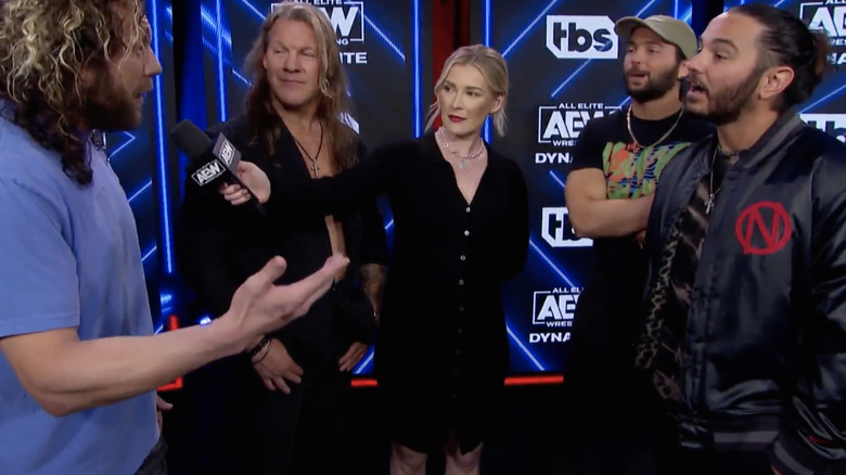 Kenny Omega with Chris Jericho, Renee Paquette, and the Young Bucks