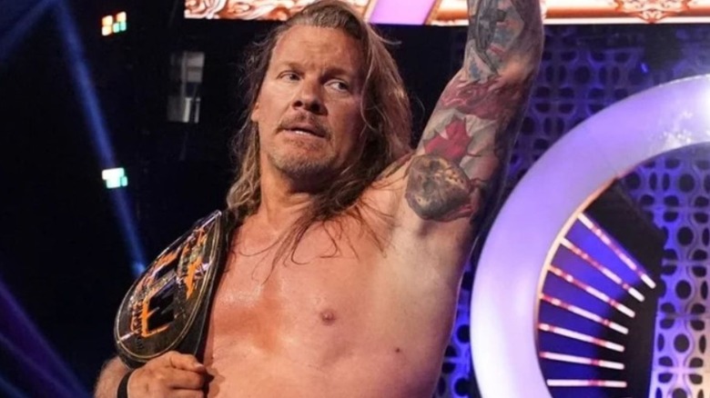 Chris Jericho stands on the stage with his newly-won FTW Championship at AEW Dynasty.
