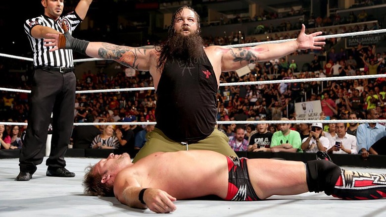 Bray Wyatt towers over Chris Jericho after defeating him in a match at SummerSlam.