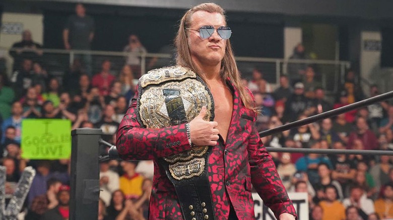 Chris Jericho walking with the AEW World Championship into the ring during an AEW show.