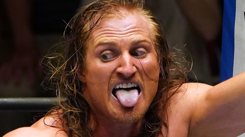 Clark Connors sticking his tongue out during a match in NJPW