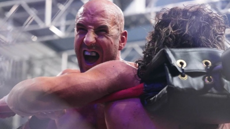 Claudio Castagnoli stands open mouthed after hitting Kenny Omega in the turnbuckle during AEW's Blood and Guts match.