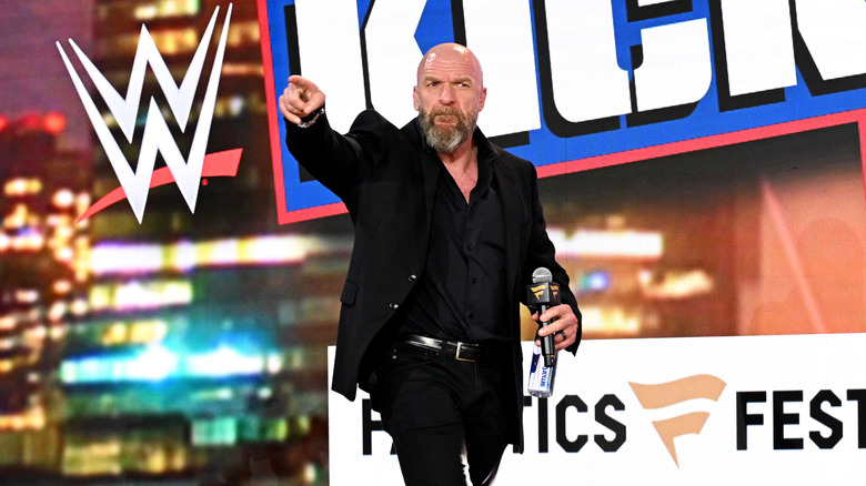 WWE CCO Triple H points towards the crowd during a Fanatics SummerSlam Takeover
