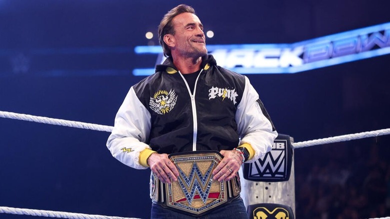 The Undisputed WWE Champion CM Punk takes in the admiration from the crowd before speaking with Cody Rhodes