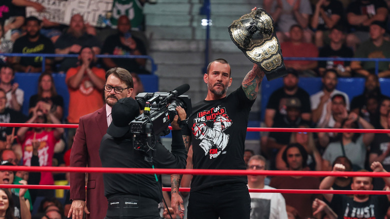 CM Punk raises his championship