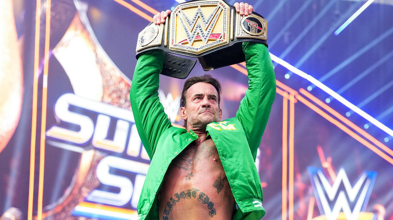 CM Punk holds up the Undisputed WWE title