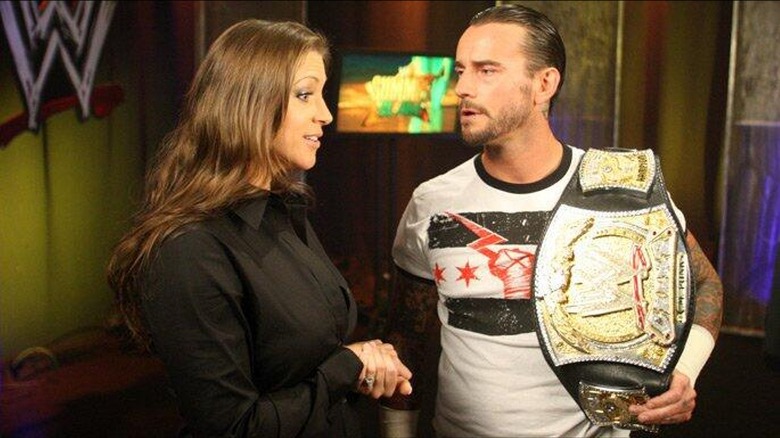 Stephanie McMahon confronting CM Punk backstage during a segment.