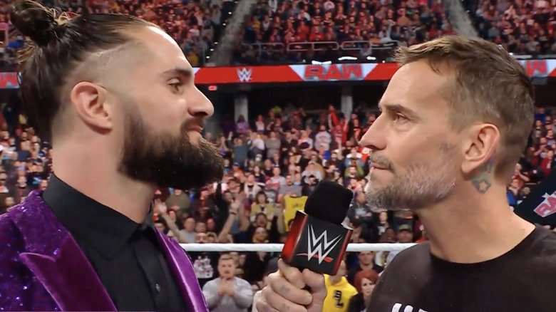 CM Punk and Seth Rollins face off in a WWE ring
