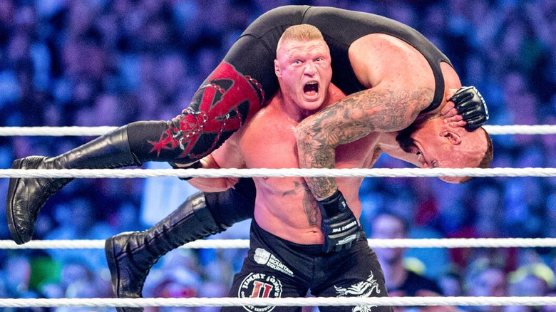 Brock Lesnar hoisting The Undertaker up on his shoulders to deliver an F5 during their WrestleMania XXX.