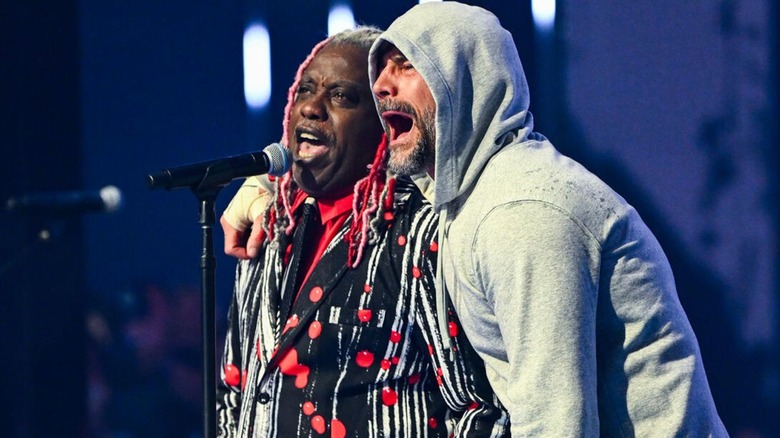 CM Punk sings along with lead singer of Living Color, Corey Glover, onstage during his entrance at WrestleMania 41.