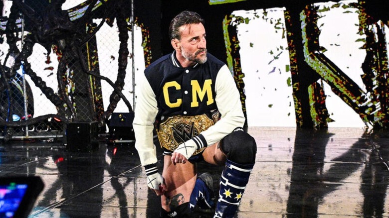 CM Punk poses on the stage before declaring 
