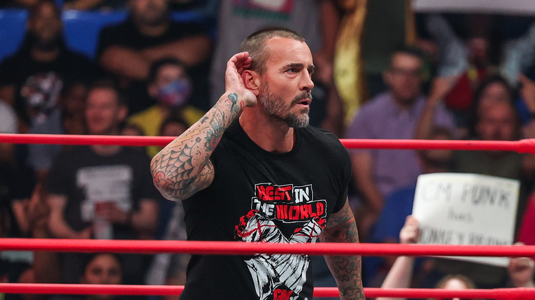 CM Punk cupping his right ear