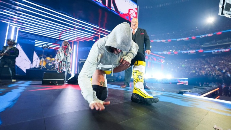 CM Punk hits his signature pose on the stage as Living Colour plays his entrance music ahead of his match at WrestleMania 41.