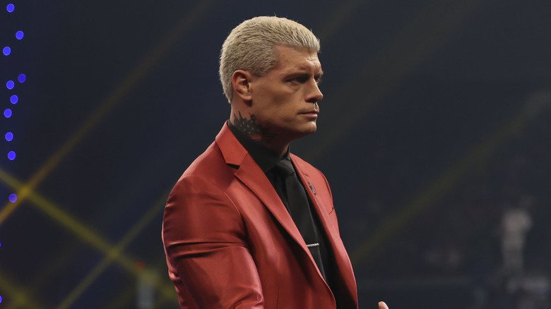 Cody Rhodes looks stern while in a red suit