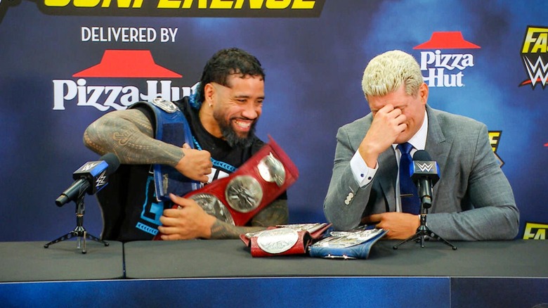 Jey Uso and Cody Rhodes with the Undisputed WWE Tag Team Championships at a press conference