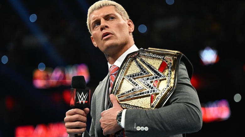 Undisputed WWE Champion Cody Rhodes cuts a promo in the middle of the ring, title on his shoulder, during a episode of WWE programming.
