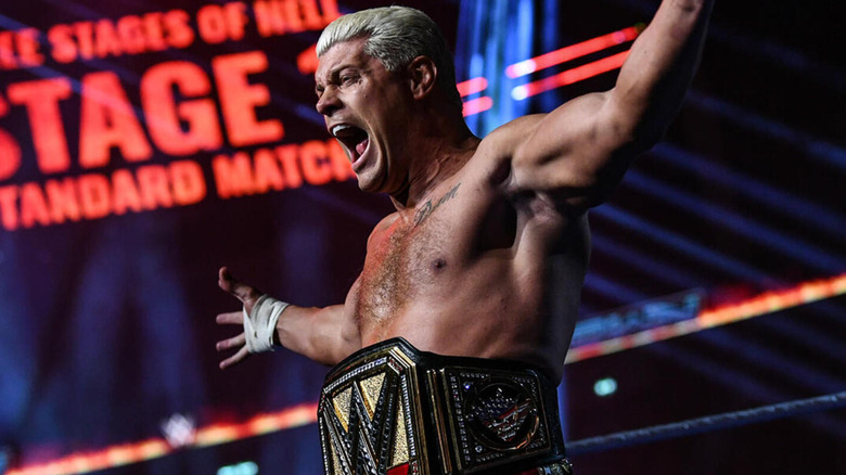 Cody Rhodes shouts as he proudly wears the Undisputed WWE Championship title.