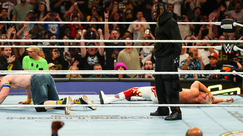 R-Truth standing over John Cena and Cody Rhodes