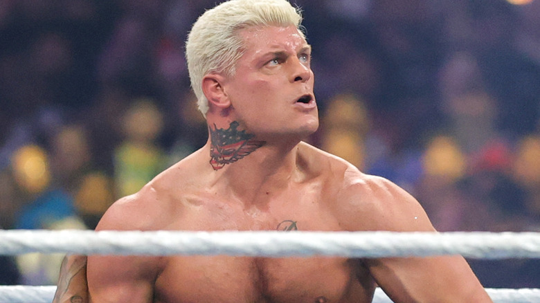 Cody Rhodes looks up as he sets Travis Scott up for a Crossroads off-shot.