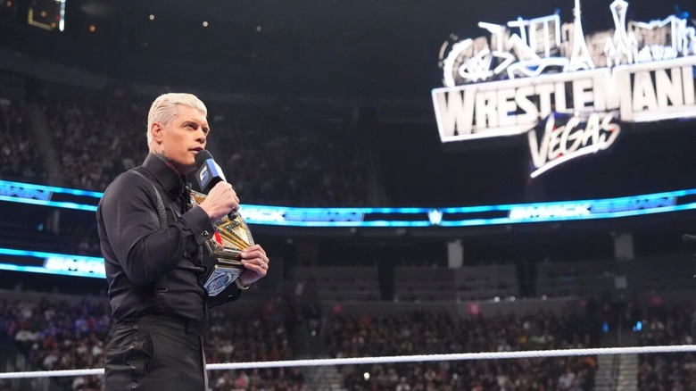 Undisputed WWE Champion Cody Rhodes cuts a promo in the ring, the WrestleMania 42 sign looming in the background.
