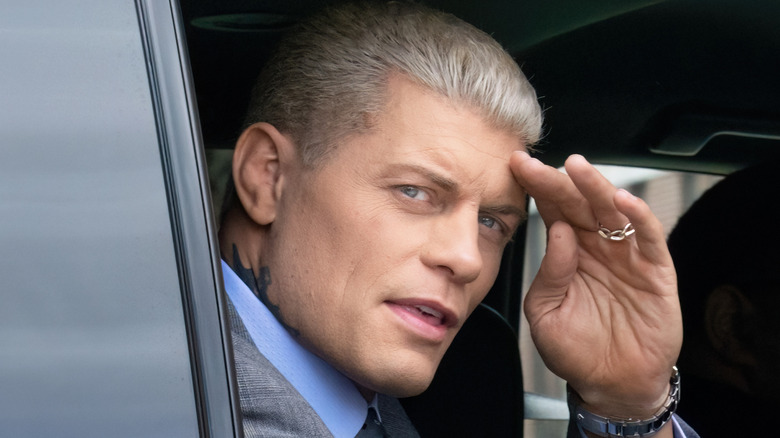 Cody Rhodes saluting in a car