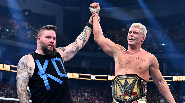 Kevin Owens raising the arm of Cody Rhodes after a match