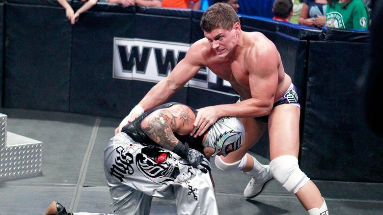 Cody Rhodes and Rey Mysterio clashing during a 